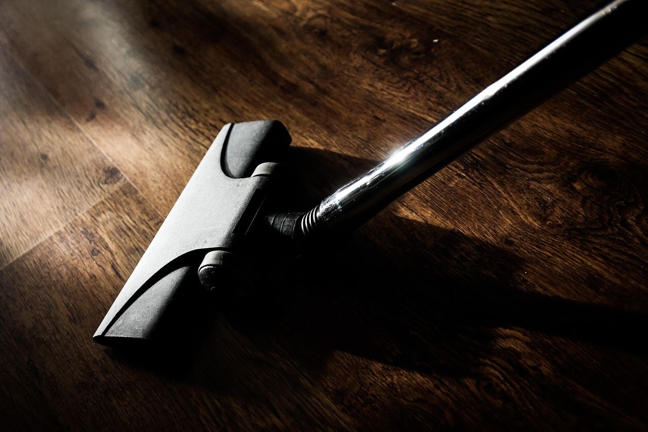 Brosse d un aspirateur sans fil sur un parquet en bois